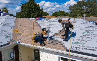 APC-Roofing-in-Florida-Roofers are installing shingle roofs on a house